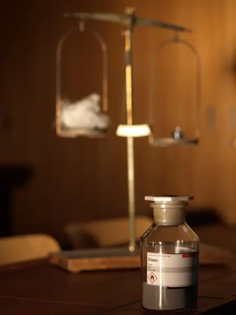 Balkenwaage und Chemikalie in Glasbehlter